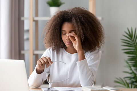 Woman rubbing her dry eyes