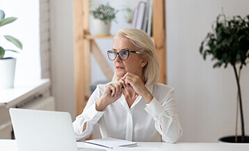 Woman in eyeglasses with laptop