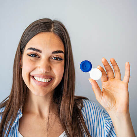 Happy woman with contacts case